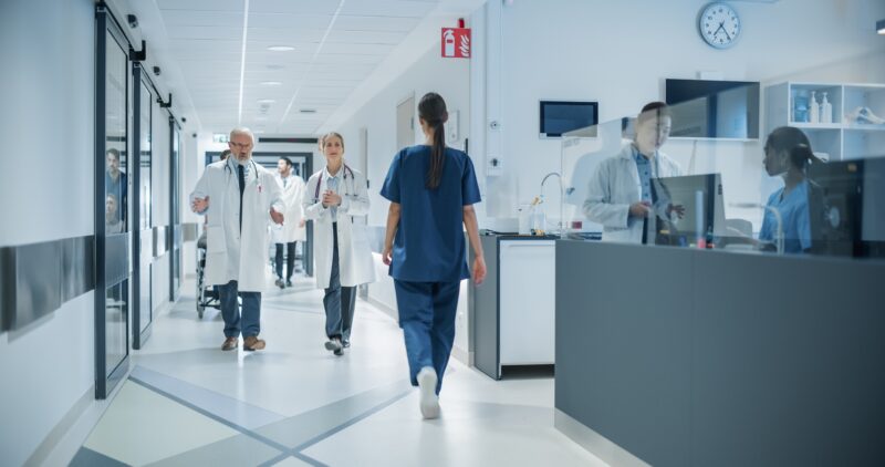Diverse,Male,And,Female,Medical,Professionals,Navigate,A,Busy,Hospital
